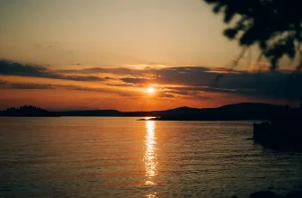 A vibrant sunset reflecting on the calm coastal waters of Desolation Sound during a British Columbia yacht charter