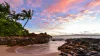 Intimate crescent of golden sand and black lava rock at Secret Beach in South Maui, a popular anchorage for a Maui yacht charter