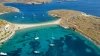 Aerial view of boats in the water and shoreline at Kolona Beach, Kythnos, Cyclades, Greece