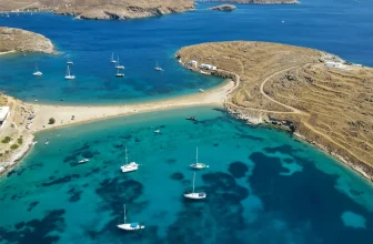 Aerial view of boats in the water and shoreline at Kolona Beach, Kythnos, Cyclades, Greece