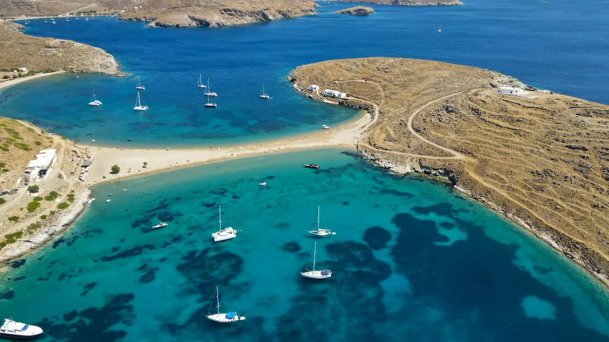 Aerial view of boats in the water and shoreline at Kolona Beach, Kythnos, Cyclades, Greece