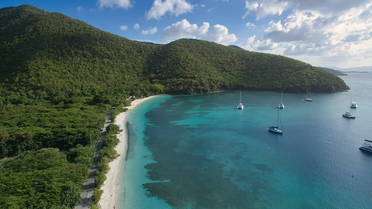 Aerial view of turquoise bay, sandy beach and anchored sailboats at St. John, USVI