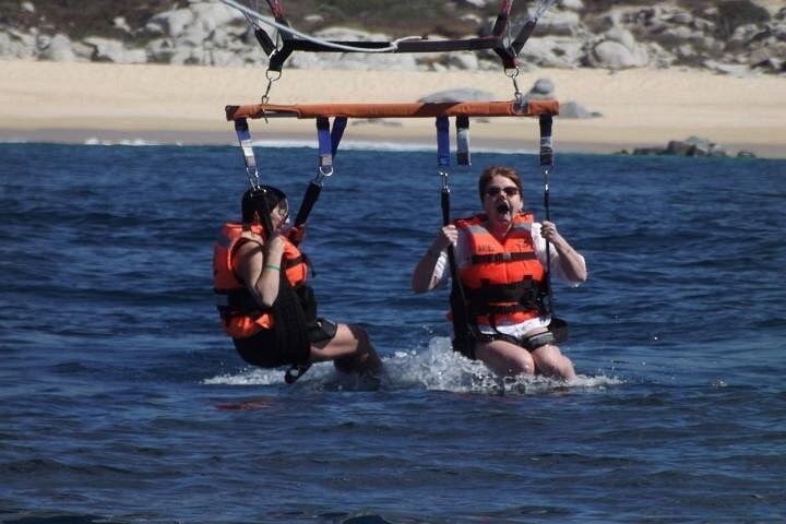 Ladies getting a little wet when landing. - Single or Double Parasailing in Cabo with Views of The Arch