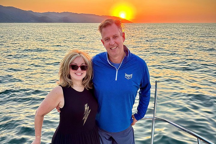 Enjoying the sunset from the bow with panoramic ocean views. - Puerto Vallarta: Luxury Yacht Sunset Cruise with Premium Open Bar
